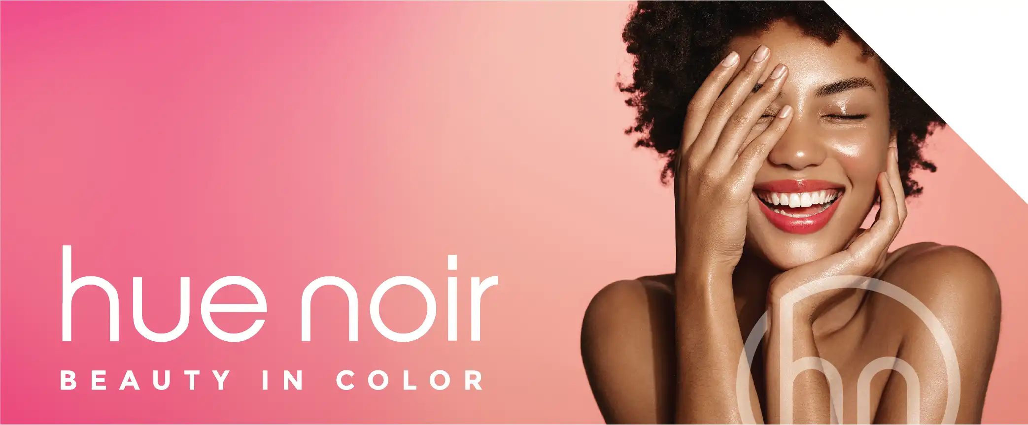 Hue Noir Logo with Smiling woman feeling her soft skin